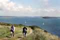 Walkers along coastal trail in Pembrokeshire. Wales