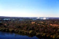 Zambezi River surrounded by jungle with mist of Victoria Falls beyond. Zimbabwe.